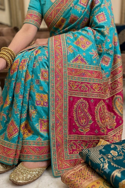 Turquoise tussar silky saree with pink patola and paisley zari border