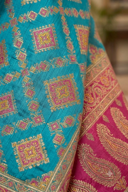 Turquoise tussar silky saree with pink patola and paisley zari border
