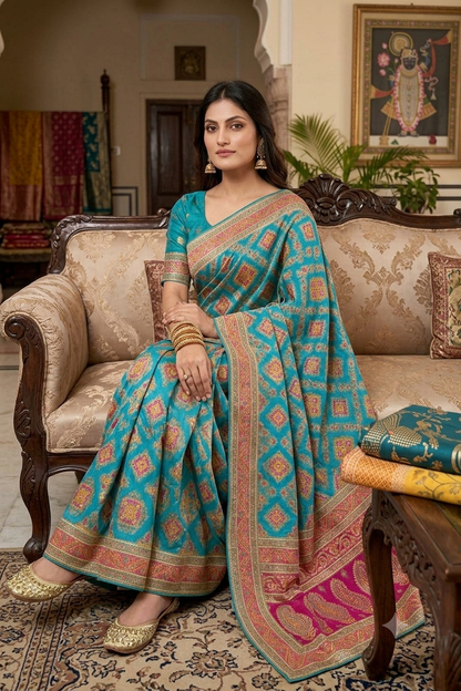 Turquoise tussar silky saree with pink patola and paisley zari border