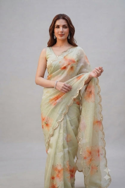Elegant Pastel Green Floral Organza Saree with Scalloped Mirror-Work Border